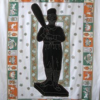 From the series American Memento Mori: Baseball - applique and embroidery on vintage textile. A folk art figure of a baseball player in silhouette with a skeleton head is appliquéd onto a colorful vintage tablecloth, and embellished with white embroidery.