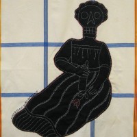 From the series American Memento Mori: Baby - applique and embroidery on vintage textile. A folk art portrait of a baby in silhouette with a skeleton head is appliquéd onto a colorful vintage tablecloth, and embellished with white embroidery.